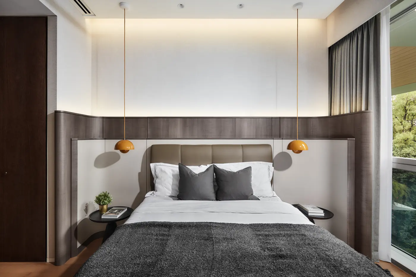 Master bedroom with curved headboard and Flowerpot pendants