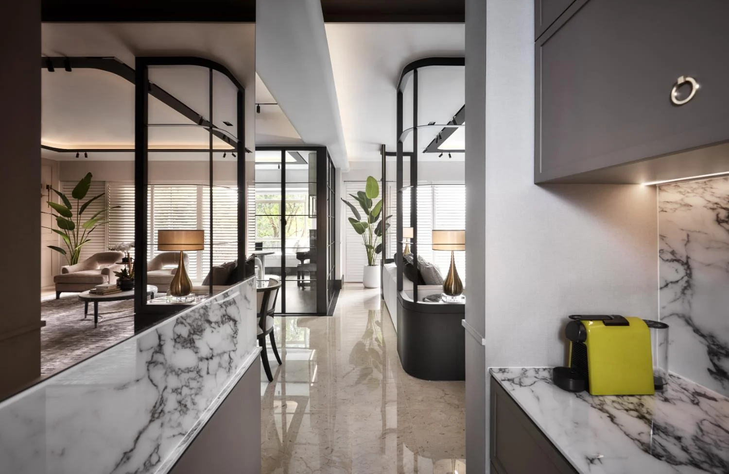 Kitchen reflection — polished surface catching cove light, creating spatial depth in the working area